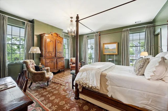 a bedroom with a bed and a chandelier