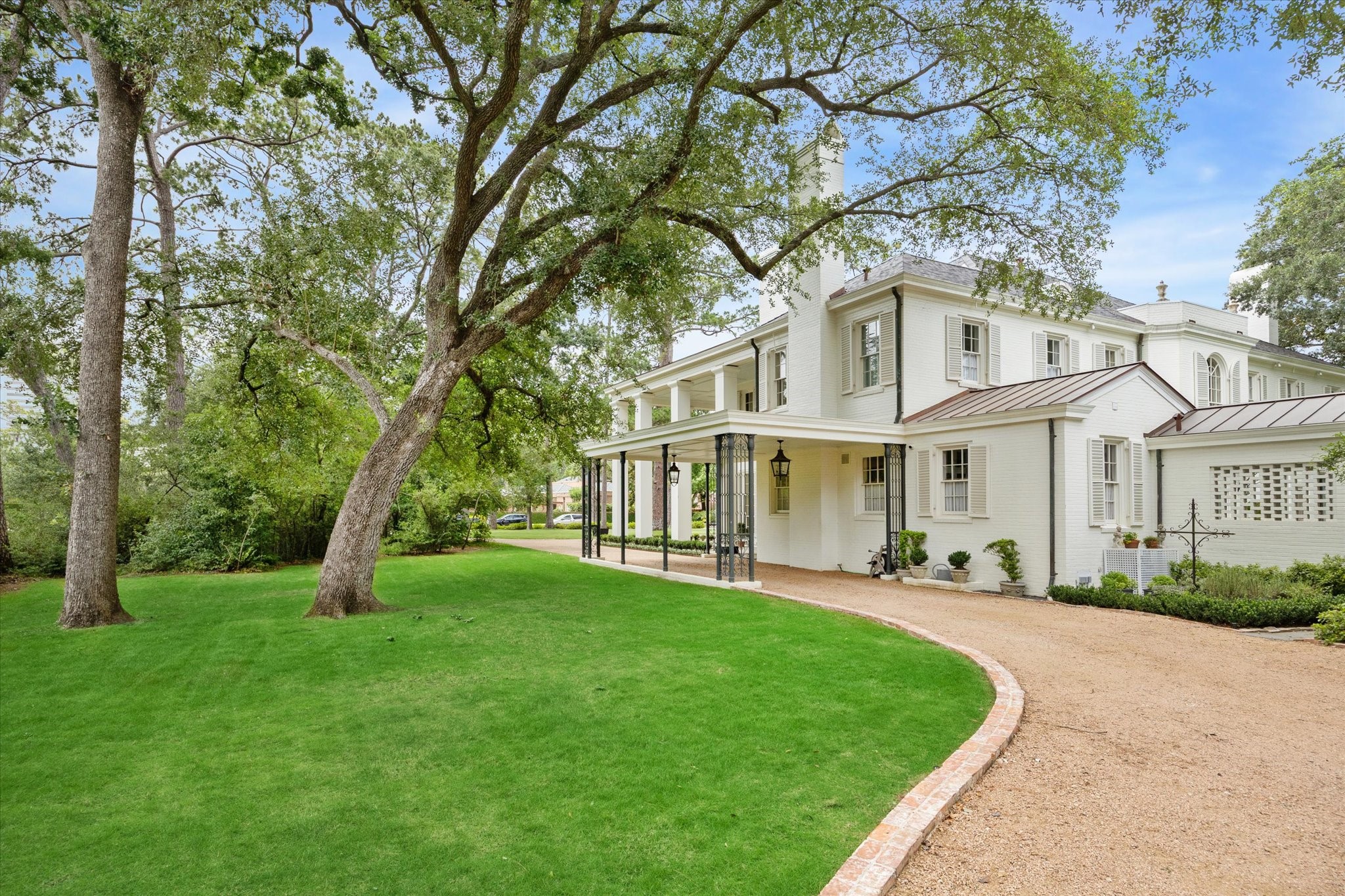 4019 Inverness Drive Houston, TX 77019 - Photo 35 of 49 a view of a white house with a big yard and large trees