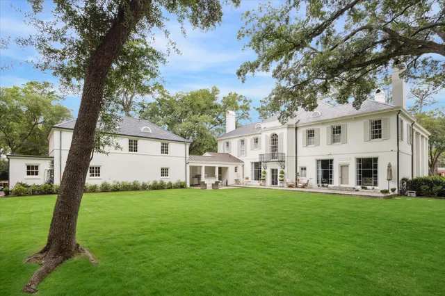 a front view of a house with yard and green space