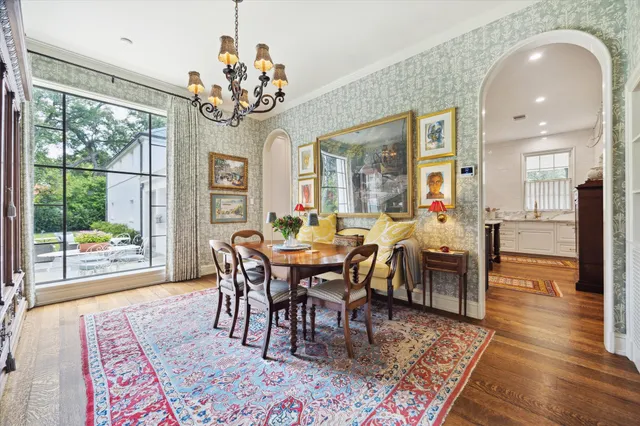 a view of a dining room with furniture wooden floor and chandelier
