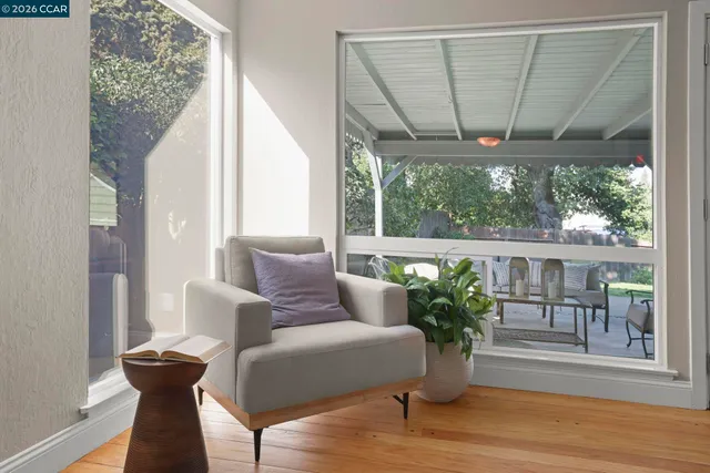 a living room with furniture and a potted plant