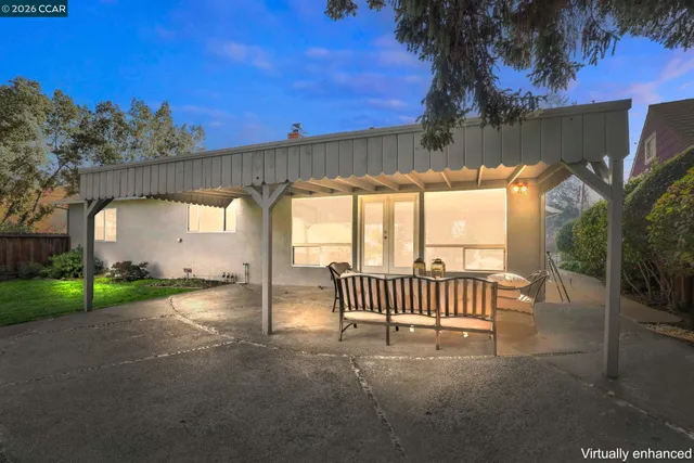 a view of a porch with a floor to ceiling window and a yard
