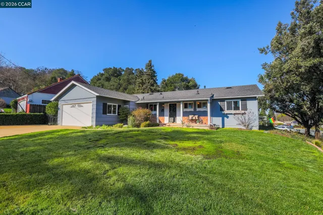 a front view of house with yard and green space