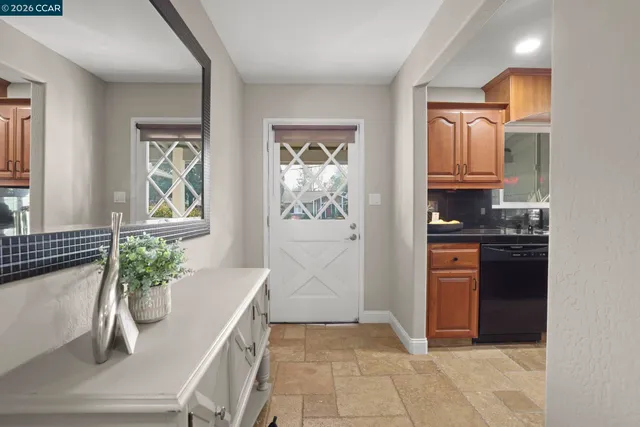 a kitchen with stainless steel appliances a counter space and a window