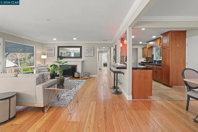 a living room with furniture a counter space and a wooden floor