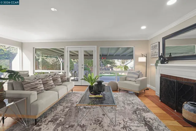 a living room with furniture large window and a fireplace