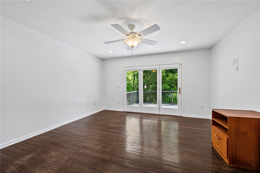 118 Beacon Ridge Circle Salem, SC 29676 - Photo 17 of 45 Rich hardwood flooring leads to a glass door balcony, extending living space to the outdoors.