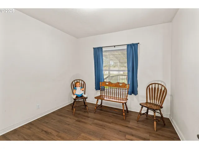 a view of workspace with wooden floor and lounge chair