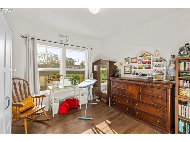 a living room with furniture a flat screen tv and a large window