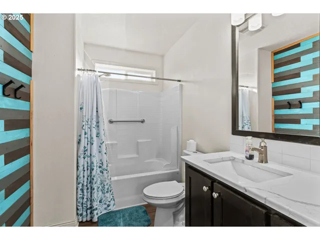 a bathroom with a granite countertop sink toilet a shower and a mirror