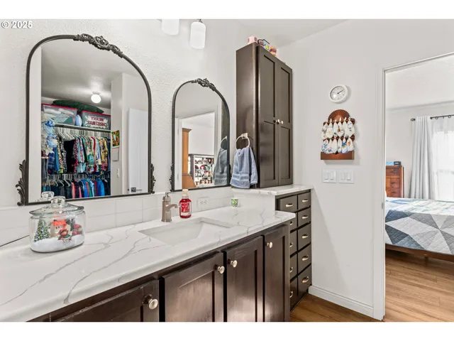 a bathroom with a double vanity sink and a mirror