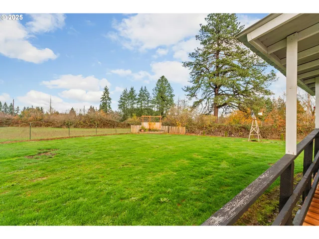a view of a field of grass and trees