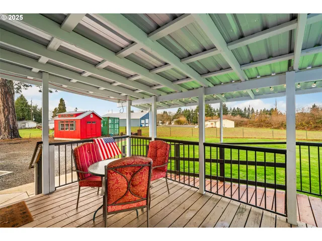 a view of a porch with furniture and garden view