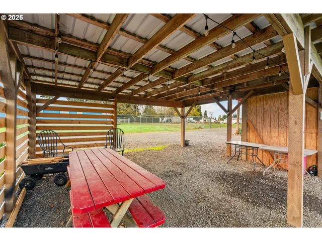 a front view of house with yard and trees in the background