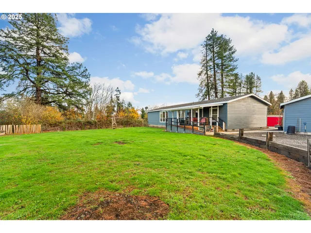 a view of a backyard with a wooden fence