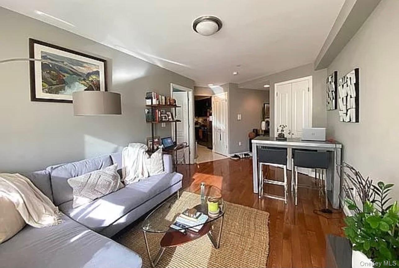 456 West 167th Street, Unit 6C Manhattan, NY 10032 - Photo 4 of 11 a living room with furniture kitchen view and a potted plant