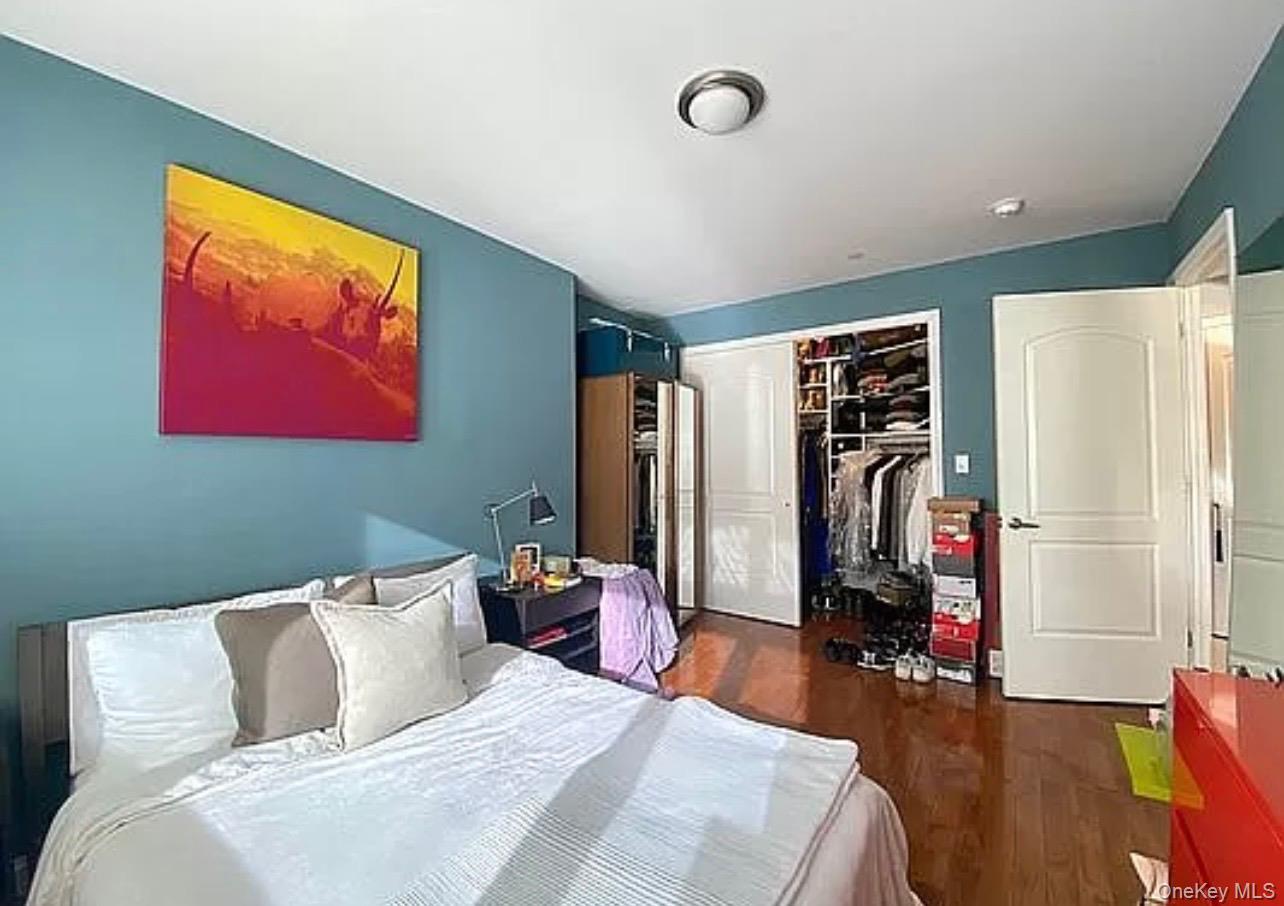 456 West 167th Street, Unit 6C Manhattan, NY 10032 - Photo 6 of 11 a bedroom with a bed and a flat screen tv