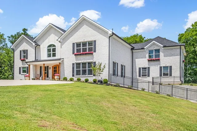 a front view of a house with a garden