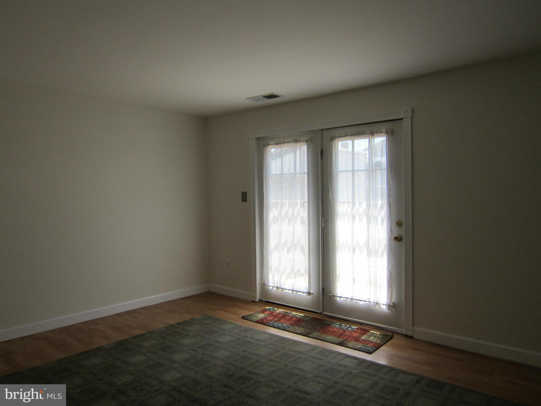 8576 Beacon Point Road Pasadena, MD 21122 - Photo 8 of 17 Sliding glass door out to patio and gazebo