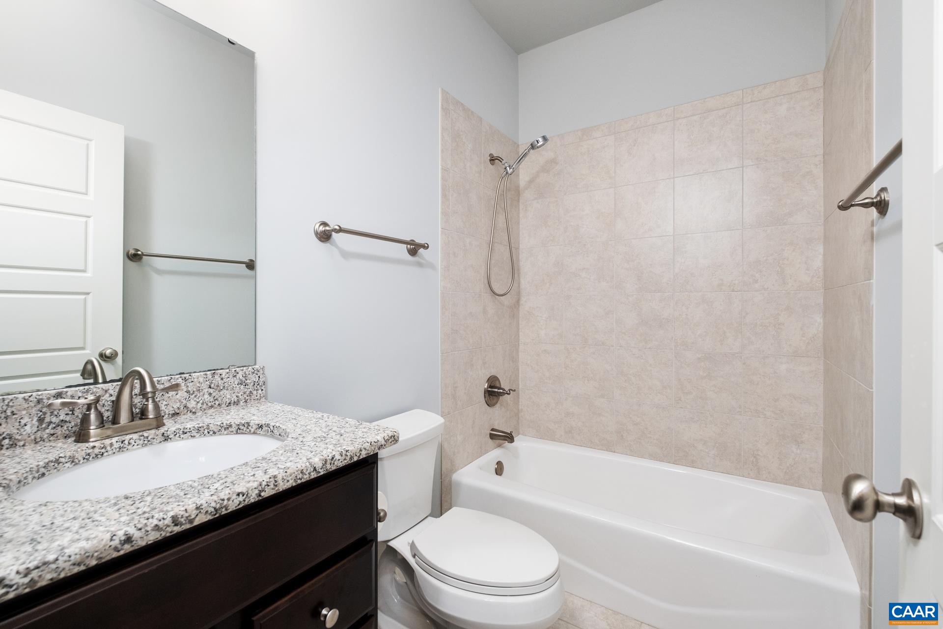 2032 Avinity Loop Charlottesville, VA 22902 - Photo 19 of 35 a bathroom with a granite countertop bathtub shower sink vanity mirror and toilet