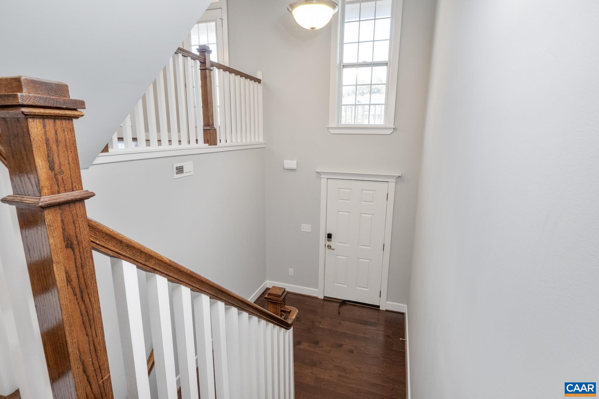 2032 Avinity Loop Charlottesville, VA 22902 - Photo 2 of 35 a view of a hallway with wooden floor and entryway