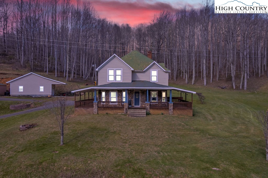 a view of a house with a yard and sitting area