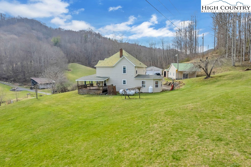 2136 Little Laurel Road Creston, NC 28615 - Photo 14 of 44 a view of a house with a yard