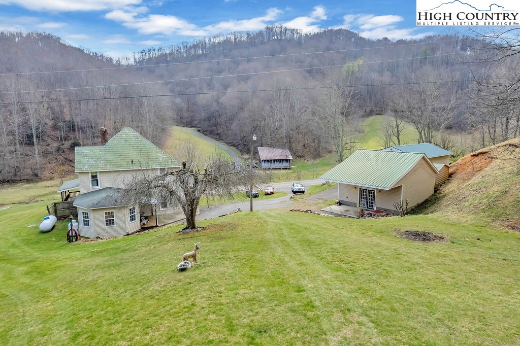 2136 Little Laurel Road Creston, NC 28615 - Photo 16 of 44 a backyard of a house with table and chairs