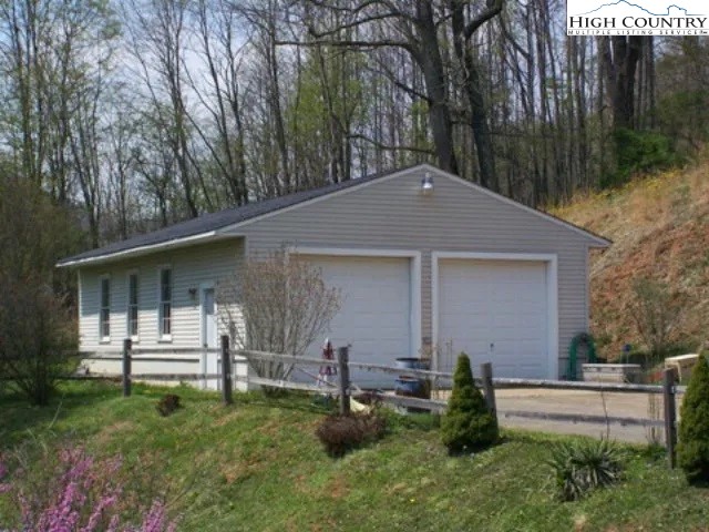 2136 Little Laurel Road Creston, NC 28615 - Photo 18 of 44 a front view of a house with a yard