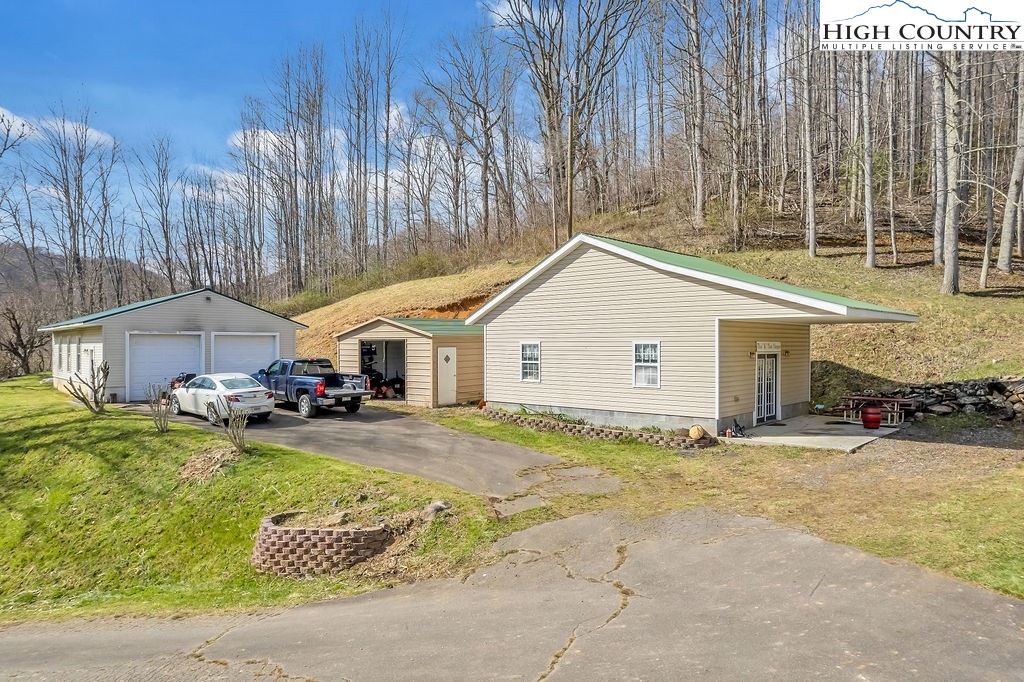 2136 Little Laurel Road Creston, NC 28615 - Photo 25 of 44 a view of a house with a yard