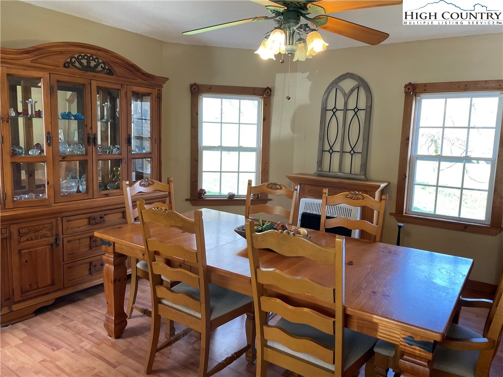 2136 Little Laurel Road Creston, NC 28615 - Photo 27 of 44 a view of a dining room with furniture window and wooden floor