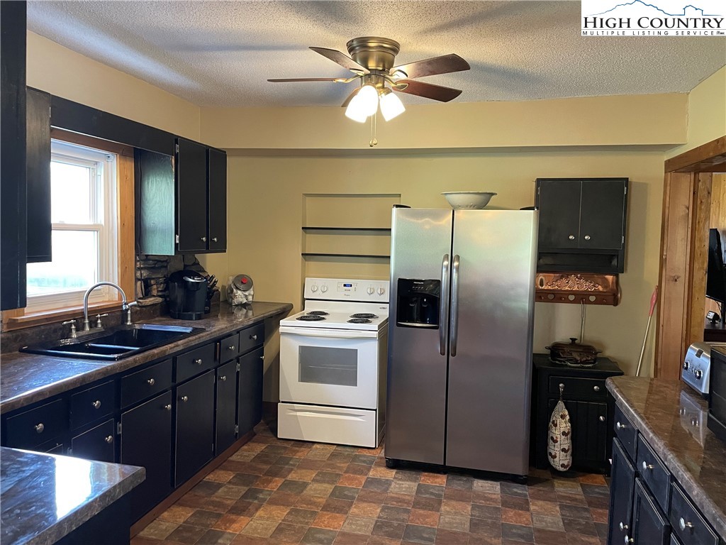 2136 Little Laurel Road Creston, NC 28615 - Photo 29 of 44 a kitchen with a sink appliances and cabinets