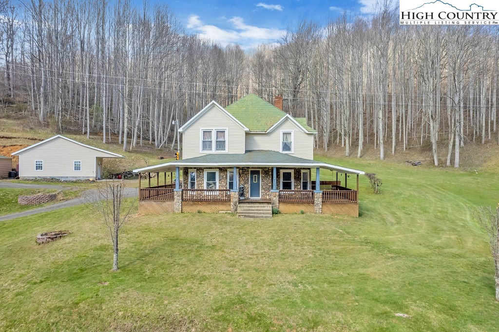 2136 Little Laurel Road Creston, NC 28615 - Photo 3 of 44 a view of a house with a yard and sitting area