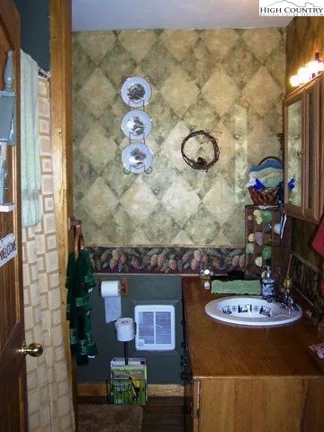 2136 Little Laurel Road Creston, NC 28615 - Photo 31 of 44 a view of a bathroom with a sink and a mirror