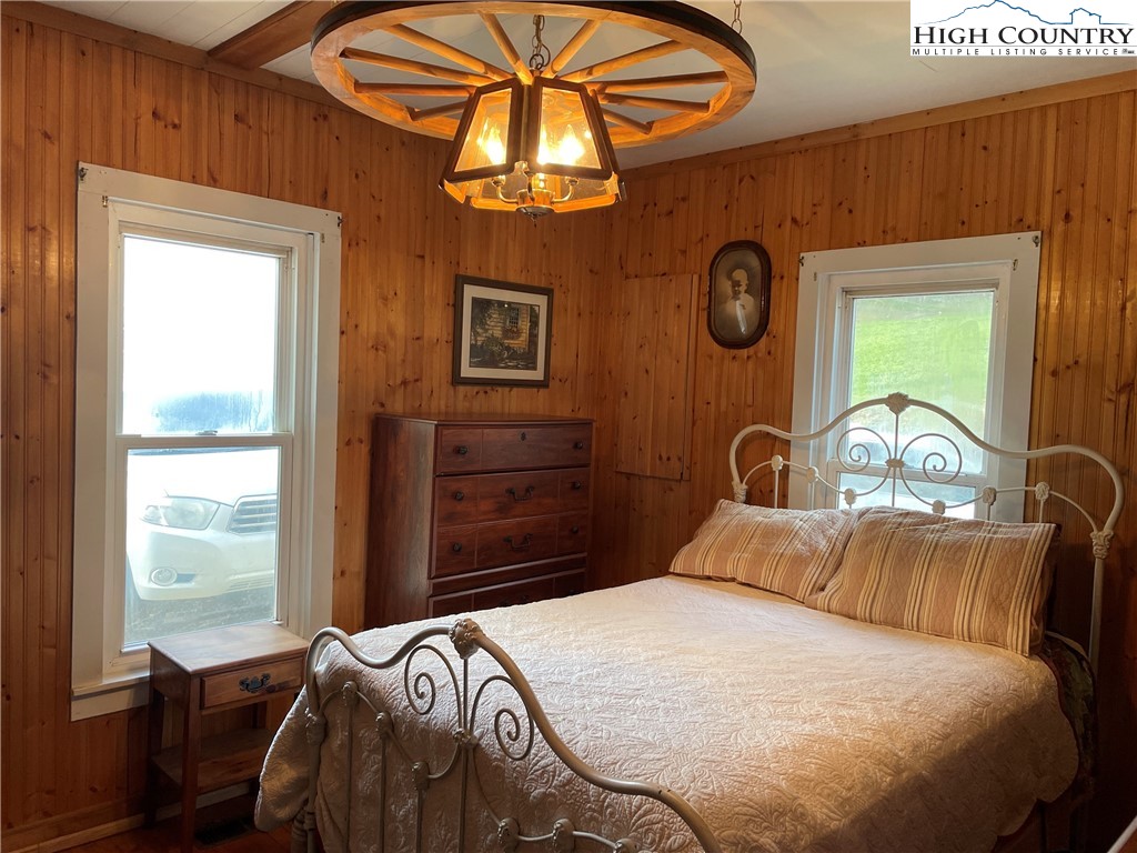 2136 Little Laurel Road Creston, NC 28615 - Photo 32 of 44 a bedroom with a bed a dresser and next to a window