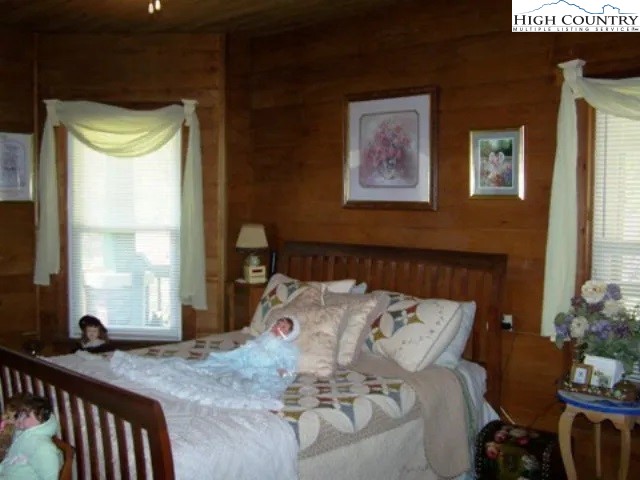 2136 Little Laurel Road Creston, NC 28615 - Photo 33 of 44 a bed sitting in a bedroom next to a window