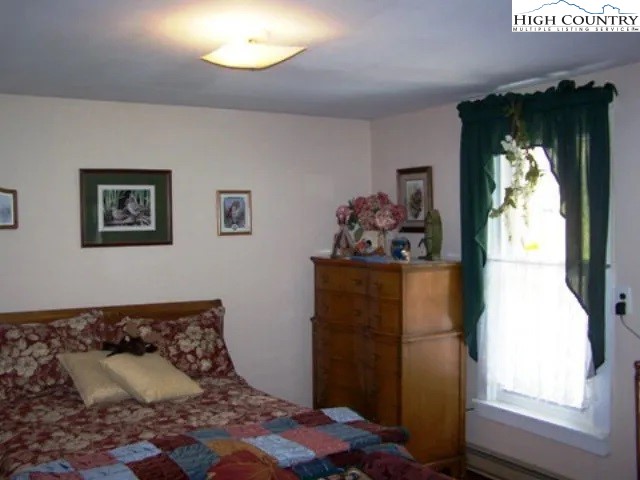 2136 Little Laurel Road Creston, NC 28615 - Photo 35 of 44 a bedroom with bed and window