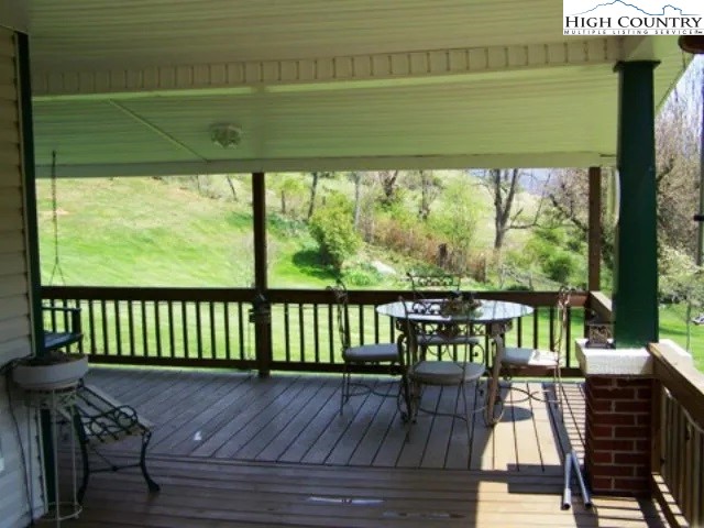 2136 Little Laurel Road Creston, NC 28615 - Photo 37 of 44 a view of balcony with wooden floor and outdoor seating