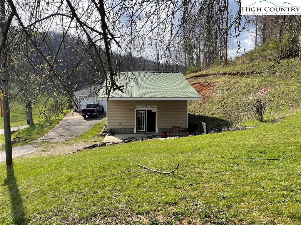 2136 Little Laurel Road Creston, NC 28615 - Photo 43 of 44 a view of a house with backyard and tree