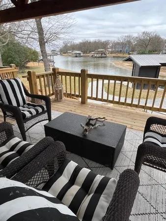a view of a balcony with chair and wooden floor