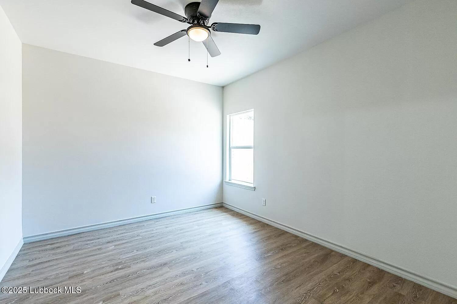 2113 20th Street, Unit A & B Lubbock, TX 79411 - Photo 17 of 31 an empty room with a window and a fan