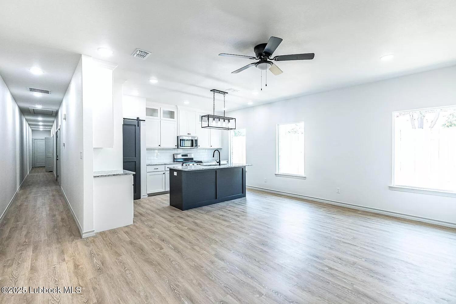 2113 20th Street, Unit A & B Lubbock, TX 79411 - Photo 2 of 31 a view of kitchen with stainless steel appliances wooden floor and window