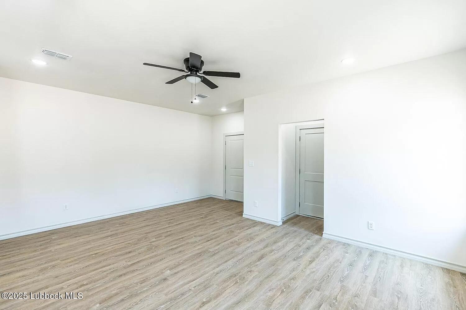 2113 20th Street, Unit A & B Lubbock, TX 79411 - Photo 21 of 31 a view of a room with wooden floor and ceiling fan