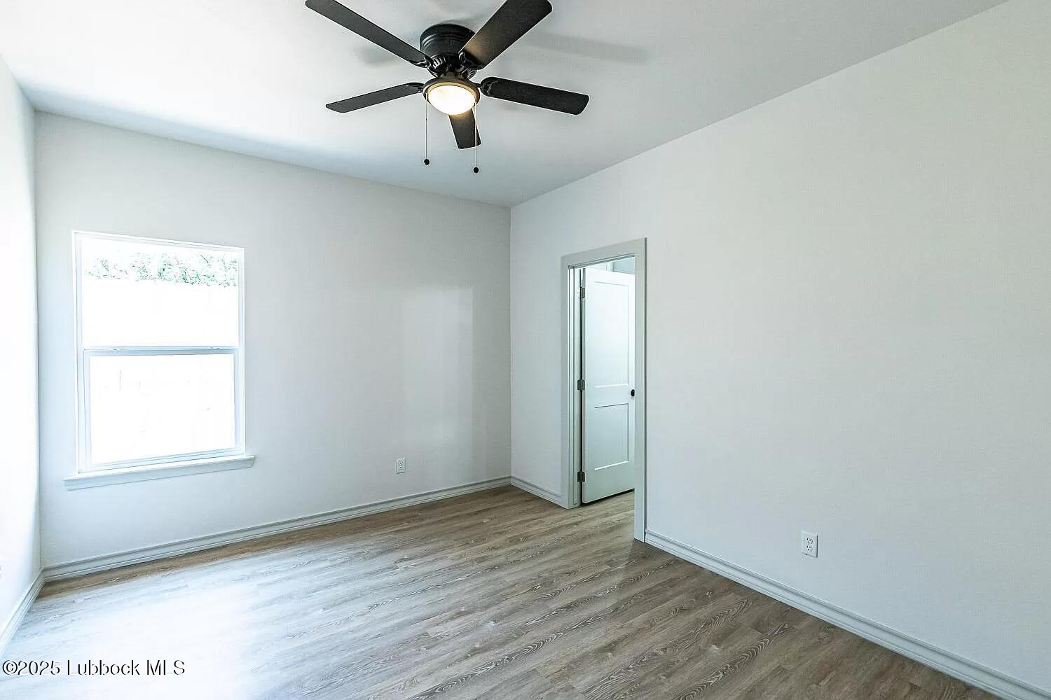 2113 20th Street, Unit A & B Lubbock, TX 79411 - Photo 24 of 31 an empty room with wooden floor and windows