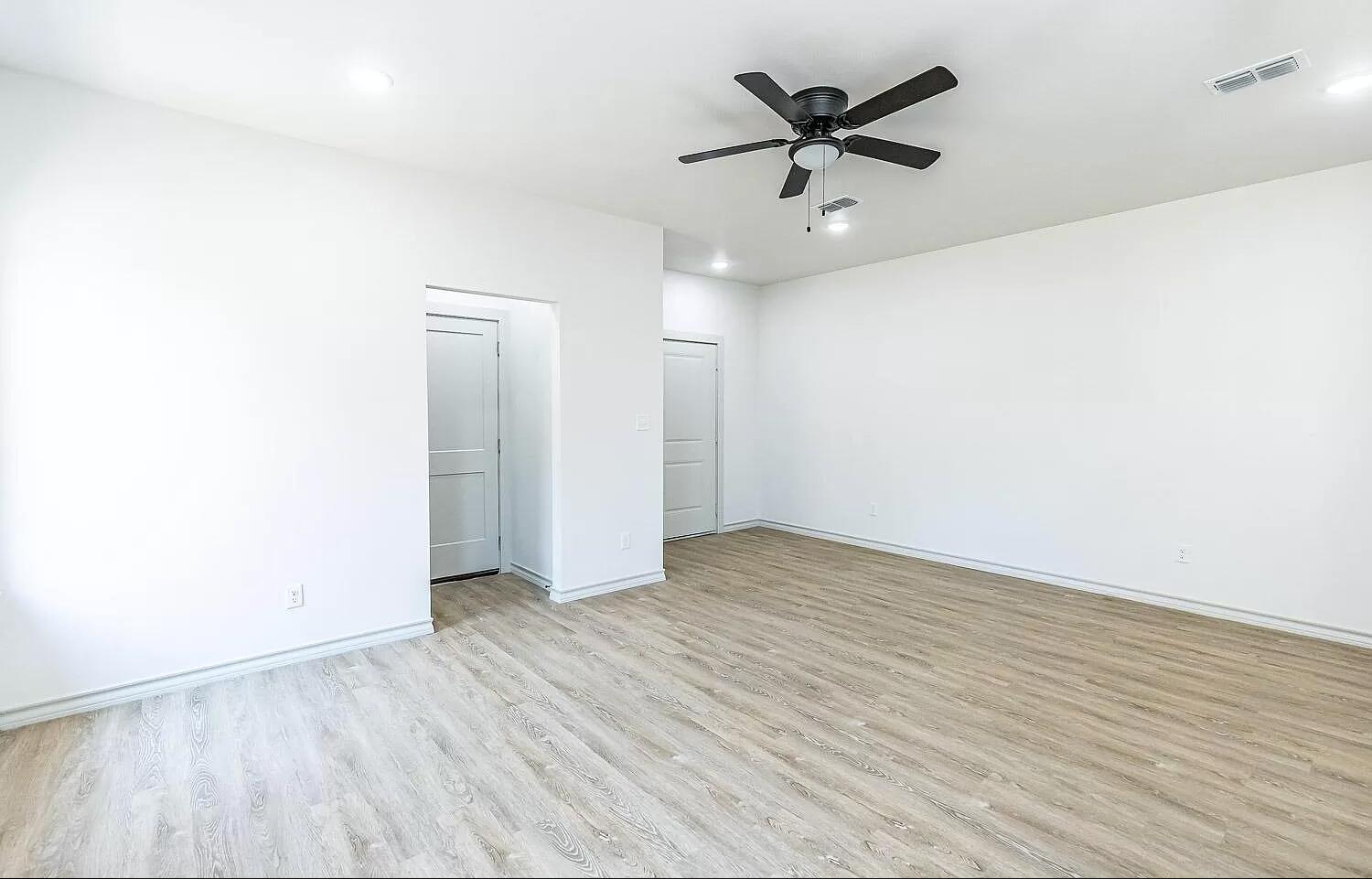 2113 20th Street, Unit A & B Lubbock, TX 79411 - Photo 28 of 31 an empty room with wooden floor and ceiling fan