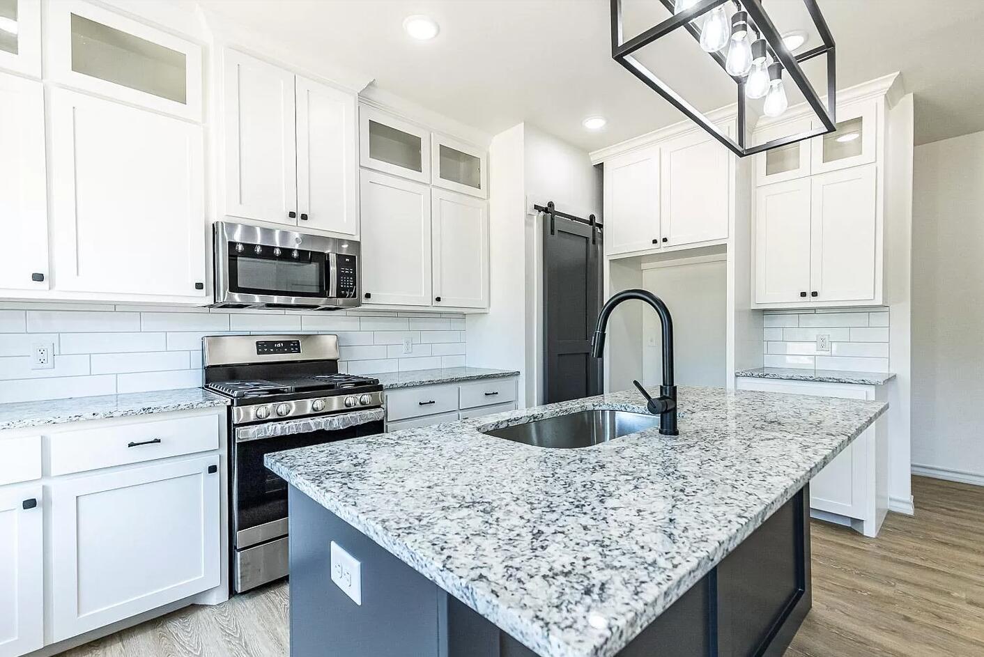 2113 20th Street, Unit A & B Lubbock, TX 79411 - Photo 31 of 31 a kitchen with granite countertop a sink and a stove