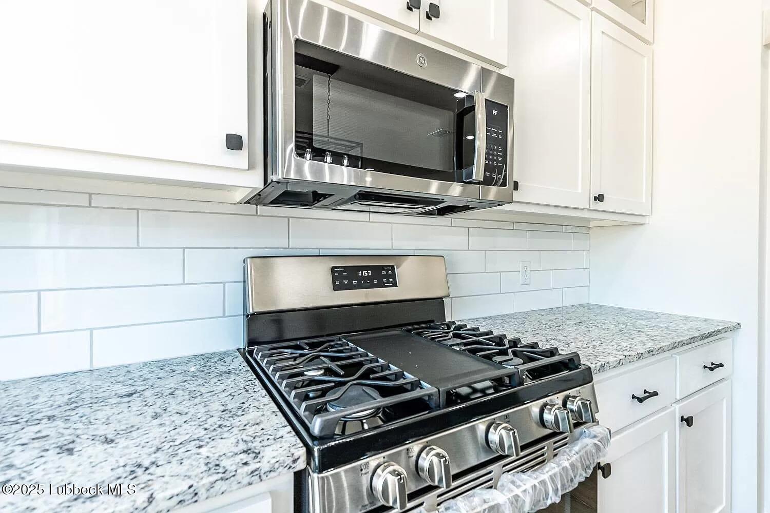 2113 20th Street, Unit A & B Lubbock, TX 79411 - Photo 4 of 31 a stove top oven sitting inside of a kitchen