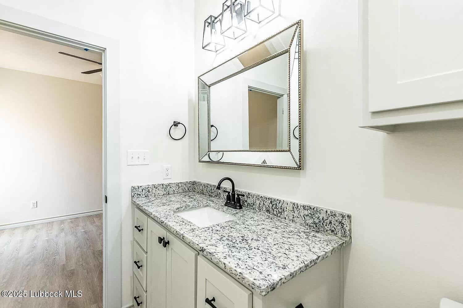 2113 20th Street, Unit A & B Lubbock, TX 79411 - Photo 7 of 31 a bathroom with a sink and a mirror