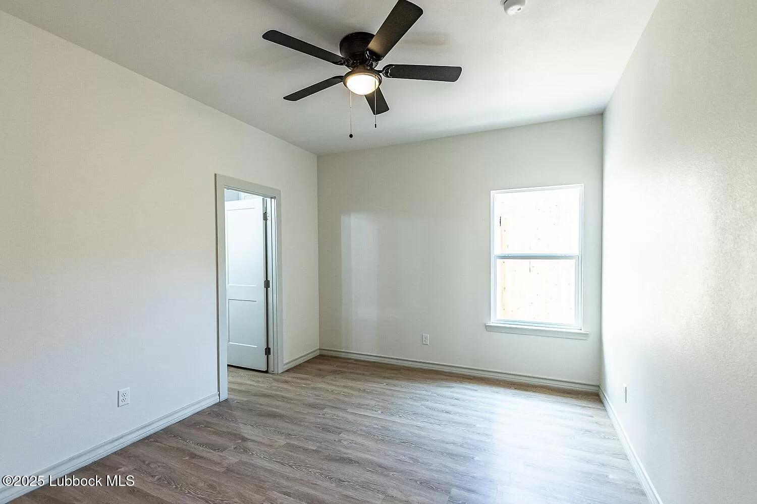 2113 20th Street, Unit A & B Lubbock, TX 79411 - Photo 9 of 31 an empty room with wooden floor and windows