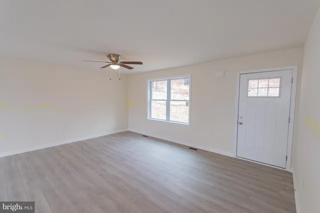 wooden floor in an empty room with a window